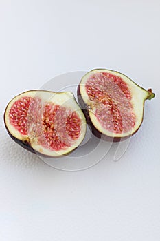 Fig fruits cut on a plate, juicy ripe flesh with seeds