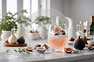 Fig and thyme summer cocktail with ice. Summer refreshing grapefruit beverage, drink, juice or smoothie with ice