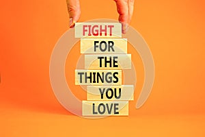 Fight for love symbol. Concept words Fight for the things you love on wooden blocks on a beautiful orange table orange background