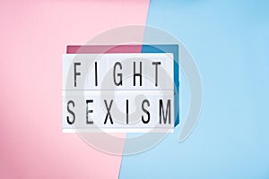 Fight sexism text on the lightbox. Feminism concept. Top view.