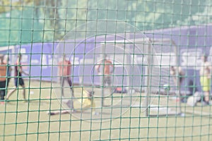 Fight for a soccer ball at the sports gate. Football training on sports field. Sportsmen, football players on training