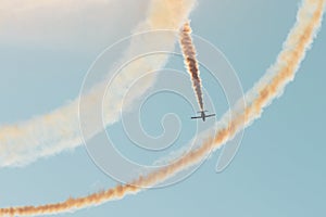 Fighter jet flies in the evening sky and smoke