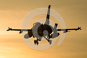 Fighter jet landing at sunset