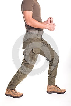 A fighter in military uniform is ready for a fight on a white background.