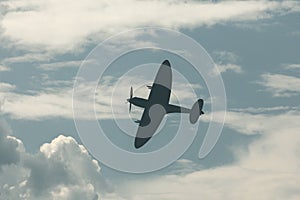 Fighter plane on cloudy sky