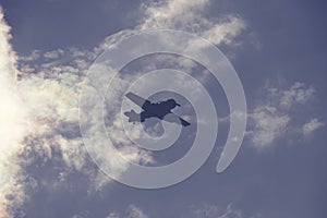 Fighter plane on cloudy sky