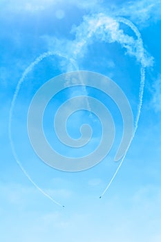 Fighter plane looping in turbo fly on the sky makes heart