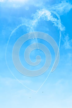 Fighter plane looping in turbo fly on the sky makes heart