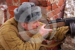 Fighter of Red army with the machine gun in ruins of Stalingrad