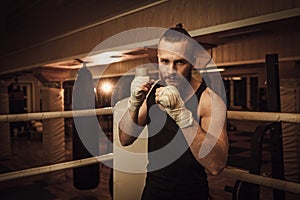 Fighter shadowboxing on training ring