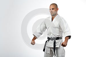 Fighter in white kimono posing on isolated