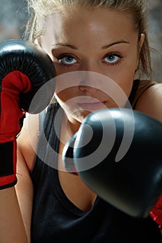 Fighter woman wearing boxing gloves