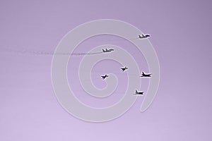 Fighters flying formation purple background