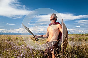 Fighting ancient warrior in landscape background