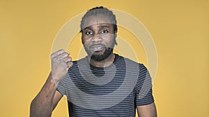 Fighting Angry Casual African Man Isolated on Yellow Background