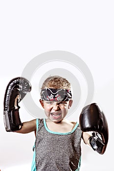 Fighting boy in Boxing gloves and bandana on light background