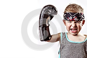 Fighting boy in Boxing gloves and bandana on light background