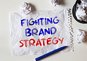 Fighting Brand Strategy lettering on crumpled white paper