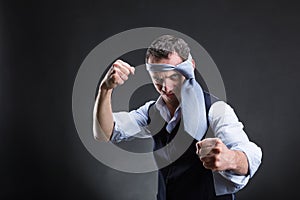 Fighting businessman with a tie on his head