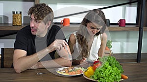 Fighting Caucasian couple smart phone addict problem while eating dinner