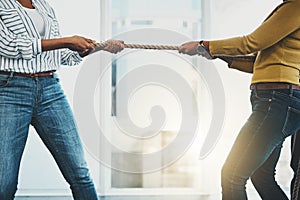 Fighting for every deal. Closeup shot of two unrecognizable women pulling on a rope during tug of war.