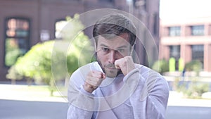 Fighting Gesture by Aggressive Business Woman Standing Outdoor