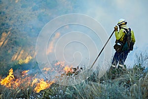 Fighting the good fight against fire. fire fighters combating a wild fire.