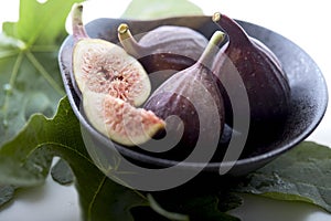 figs in a a bowl with fig leaf