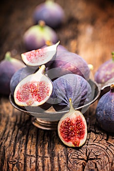 Figs. A few figs in a bowl on an old wooden background photo