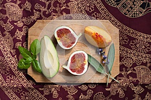 Figs and herbs on a wooden board