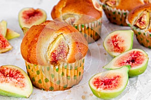 Figs muffins with fresh fruits on baking paper and wooden background