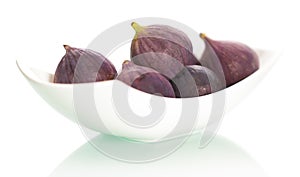 Figs on plate on white background.
