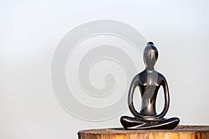 Figure of beautiful young girl meditating and do yoga on wooden surface. With empty space for text