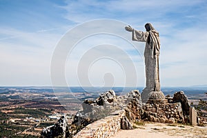 Christ the King statue looking over Castelo de Rodrigo, Portugal photo