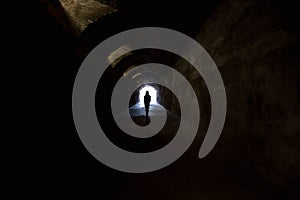 Figure in dark tunnel