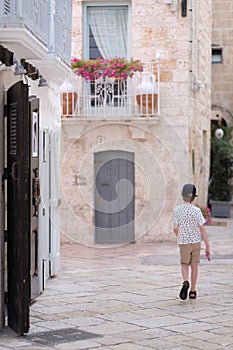 The figure of the departing boy on the small street