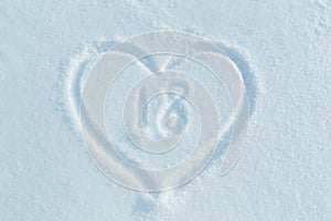 A figure of eighteen written in the snow in the painted heart.