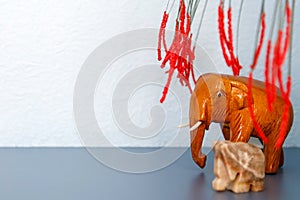 Figure of an elephant made of wood under the branches