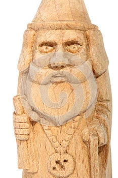 The figure of the good Wizard carved from beech with a staff and a scroll in hands. Old decorative toy. Portrait.