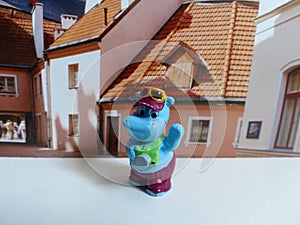 A figure of a hippopotamus tourist photographing sights. Hobby. Kinderfilia - collecting children`s toys