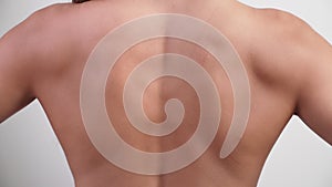 Figure of a naked woman on a white background, rear view from the back. Slim tanned woman`s body. Healthcare and medicine concept