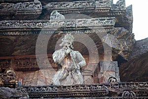Figure playing flute with all the facial expressions at 800 year old Sun Temple, Konark, India