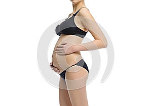 Figure of a pregnant woman in black underwear for pregnant, panties and bra on a white