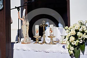 Figure of resurrected Jesus, cross and candles during Easter Holy Mass in Holloko village, Hungary photo
