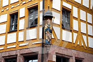 A figure of a saint on a corner of a German house.