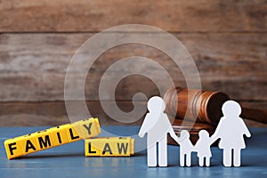 Figure in shape of people, cubes with words Family Law and gavel on wooden table
