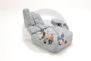 a figure sit on the big robot hand