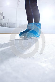 figure skater on dark ice arena background