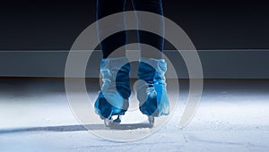 figure skater on dark ice arena background