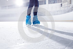 Figure skater on dark ice arena background